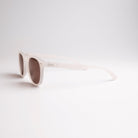 Lunettes de soleil retro Stockholm anti lumière bleue de couleur blanche sur fond blanc, de profil, logo faucon blanc sur la branche